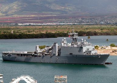 US Navy (USN) Sailors aboard the USN Whidbey Island Class Amphibious Dock Landing ship USS RUSHMORE (LSD 47) "man the rails" as the ship pulls into Naval Station Pearl Harbor. The RUSHMORE is here to take part in Rim of the Pacific (RIMPAC) 2004. RIMPAC 2004 is the largest international maritime exercise in the waters around the Hawaiian Islands. This years exercise includes seven participating nations; Australia, Canada, Chile, Japan, South Korea, the United Kingdom and the United States. RIMPAC is intended to enhance the tactical proficiency of participating units in a wide array of combined operations at sea, while enhancing stability in the Pacific Rim region