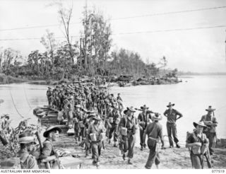 BOUGAINVILLE ISLAND. 1944-12-06. TROOPS OF THE 15TH INFANTRY BATTALION DISEMBARKING FROM THE FERRY WHICH CROSSES THE TARGESSI RIVER DURING THEIR ADVANCE TO TAKE OVER THE POSITIONS HELD BY THE 1ST ..
