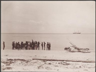 Missionaries and villagers gathered around a boat on a Pilani beach, Reef Islands, 1906 / J.W. Beattie