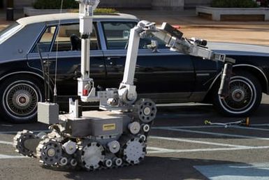A Remote Operated Neutralization System carries a simulated bomb away from a car during training at the Marine Corps Base Hawaii, Post Exchange parking lot on Dec. 9, 2004.(U.S. Marine Corps official photo by CPL. Nicholas Riddle) (Released)