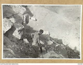 PORT MORESBY, NEW GUINEA. 1943-06-26. SAPPER OF 5TH AUSTRALIAN EMPLOYMENT COMPANY DRILLING BLASTING HOLES IN QUARRY FACE AT THE NINE MILE QUARRY