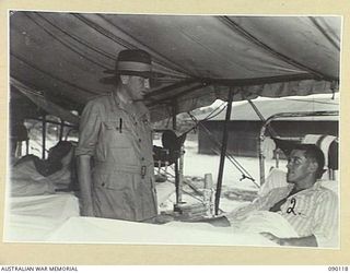 BOUGAINVILLE. 1945-03-30. LORD WAKEHURST, GOVERNOR OF NEW SOUTH WALES (1), TALKING TO SAPPER T.J. HINDEMARSH, 58 FIELD PARK COMPANY, ROYAL AUSTRALIAN ENGINEERS (2), DURING HIS VISIT TO THE 2/1 ..