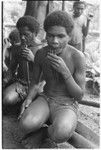 Playing 'aubinubin, or'aukwa'ikwa'i, panpipes