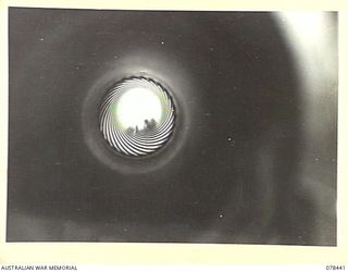 MOTUPINA POINT AREA, BOUGAINVILLE ISLAND. 1945-01-20. LOOKING UP THE BARREL OF A LONG 25 POUNDER OF THE 2ND FIELD REGIMENT, SHOWING THE CLEARLY DEFINED RIFLING IN THE BARREL