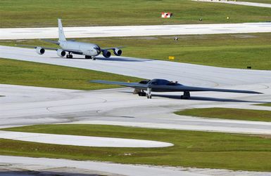 A US Air Force (USAF) B-2 Spirit stealth bomber taxis onto the flightline at Anderson Air Force Base (AFB), Guam (GU), in support of exercise Coronet Bugle 49. The B-2 is deployed to Anderson from Whiteman AFB, Missouri (MO). Close behind is a KC-135 Stratotanker refueling aircraft