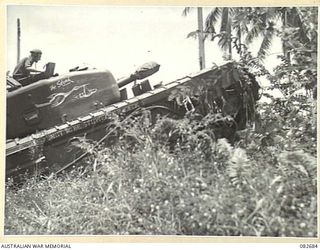 MADANG, NEW GUINEA. 1944-10-12. A CHURCHILL V TANK BOGGED AT A CREEK CROSSING DURING TESTS CONDUCTED AT HQ 4 ARMOURED BRIGADE