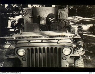 Dumpu, New Guinea. 1943-12-10. A jeep of the 85th Australian Mobile Cinema Unit, 7th Australian Division, packed and ready to move. The projector is on the left speaker and amplifier on the right ..