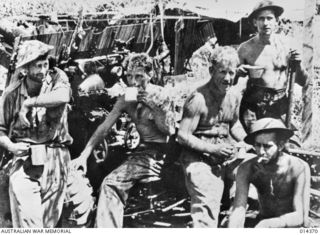 1943-03-03. PAPUA. JAPANESE UNSUCCESSFULLY ATTACK WAU. AUSTRALIANS TROOPS HAVE A WELL EARNED SPELL AFTER THE JAPANESE ATTACKS ON WAU AERODROME WERE REPULSED