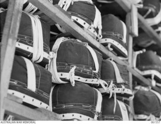 3 MILE, PORT MORESBY, NEW GUINEA. 1943-12-14. AMERICAN TYPE PARACHUTES PACKED AND READY FOR DESPATCH TO THE AIR MAINTENANCE COMPANY, WHOSE JOB IT IS TO PACK ALL THE SUPPLIES THAT ARE TO BE DROPPED. ..