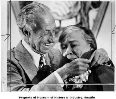 Harry Bridges giving union badge to Dixy Lee Ray, Seattle, April 18, 1977