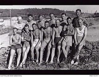 ENJOYING THE SUNSHINE AT STALAG 383 PRISONER OF WAR CAMP. THIS CAMP WAS IN THE CENTRE OF A GIANT ADVANCED TRAINING AREA. FRONT ROW FROM LEFT TO RIGHT: NX5887 CORPORAL T.H. WEST, 2/4TH BATTALION, ..