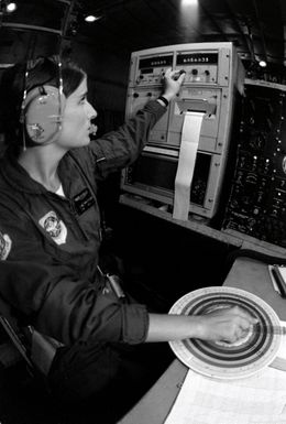 SGT. Debbie Whitacre uses a computer to transcribe, record and pass information that she received from a dropsonde sensor dropped by parachute from a WC-130 Hercules aircraft. The dropsonde is used to monitor a typhoon's direction so that the information can be promptly relayed to the Joint Typhoon Warning Center (JTWC)