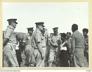 PORT MORESBY, PAPUA. 1944-08-05. MAJOR GENERAL B.M. MORRIS, DSO, GENERAL OFFICER COMMANDING, AUSTRALIAN NEW GUINEA ADMINISTRATIVE UNIT (1) TALKING WITH A VILLAGE COUNSELLOR DURING HIS OFFICIAL ..
