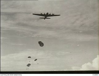 LOS NEGROS ISLAND, ADMIRALTY ISLANDS. C. 1944-03. US AIR FORCE B17 FLYING FORTRESS AIRCRAFT DROPPING BLOOD PLASMA AND FOOD BY PARACHUTE TO GROUND TROOPS AT MOMOTE STRIP