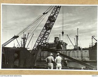 LAE, NEW GUINEA, 1943-11-05. LINK BELT SPEEDER CRANE LIFTING TIMBER FOR THE FIRST LIBERTY DOCK BEING CONSTRUCTED BY THE 1052ND ENGINEERS PORT CONSTRUCTION AND REPAIR GROUP, UNITED STATES ARMY