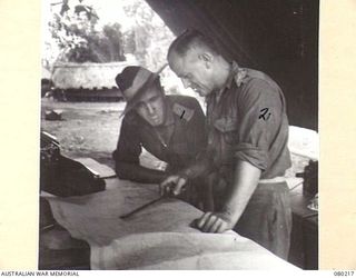 HANSA BAY, NEW GUINEA. 1944-07-08. QX16123 CAPTAIN R. VARDANEGA, OF HEADQUARTERS 5TH DIVISION, AUSTRALIAN ARMY SERVICE CORPS (1), WITH NG2076 CAPTAIN E.P. HITCHCOCK (2), AT NO. 5 PLATOON, A ..