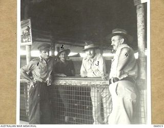 BUNA, NEW GUINEA. 1944-06-14/02. AUSTRALIAN ARMY PERSONNEL IN THE OFFICE OF THE 12TH WATER TRANSPORT OPERATING COMPANY. THEY ARE:- NX4078 CAPTAIN D.F. HERBERT, SKIPPER OF THE AK94 (1); CORPORAL ..