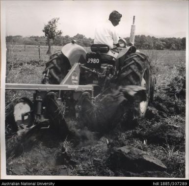 Farmer riding tractor