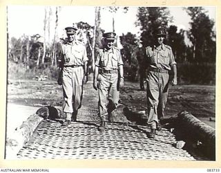 DRINIUMOR RIVER ARA, NEW GUINEA. 1944-11-23. MAJOR- GENERAL J E S STEVENS, GENERAL OFFICER COMMANDING 6 DIVISION, (2), ACCOMPANIED BY HIS AIDE-DE-CAMP LIEUTENANT G F TWOHILL, (3), AND MAJOR D G ..