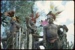 Pig festival, pig sacrifice, Kwiop: Kulakaegeyka clan men in red wigs and feather headdresses call allies to ritual fence