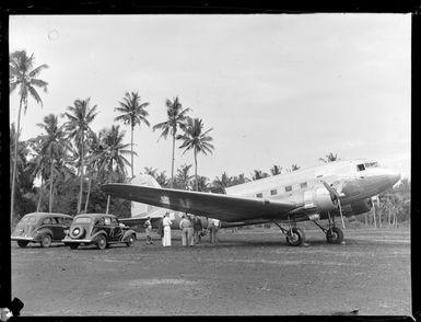 View of unidentified people getting out of RNZAF transport plane NZ3519 into cars, Faleolo Airport, Western Samoa