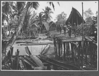 Tovei Village, Urama [Young boys standing on wooden bridge, 2]