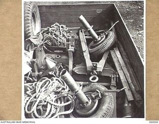 PORT MORESBY, NEW GUINEA. 1943-11-15. A SHORT 25-POUNDER GUN OF THE 2/5 AUSTRALIAN FIELD REGIMENT WHICH HAS BEEN STRIPPED TO ITS COMPONENTS, IS SHOWN IN THE BACK OF A THREE TON TRUCK TO ILLUSTRATE ..