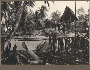 Tovei Village, Urama [Young boys standing on wooden bridge, 1]