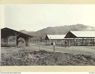 LAE, NEW GUINEA. 1944-03-24. WORKSHOPS UNDER CONSTRUCTION FOR THE 2/7TH ADVANCED WORKSHOP, AUSTRALIAN ELECTRICAL AND MECHANICAL ENGINEERS. THE FOREGROUND WILL COMPRISE MOTOR TRANSPORT REPAIR SHOPS