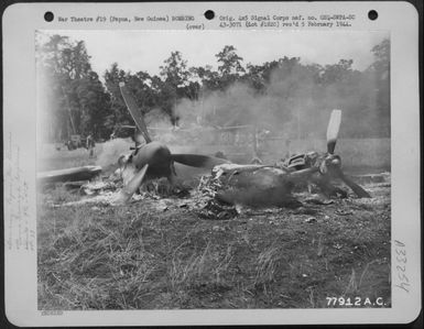 Burning Lockheed P-38 of the 9th Fighter Squadron which was hit by Japanese bombers on Air Strip #4, Dobodura, (Horando) near Port Moresby, Papua, New Guinea, 41 Division Headquarters. 11 March 1943. (U.S. Air Force Number 77912AC)