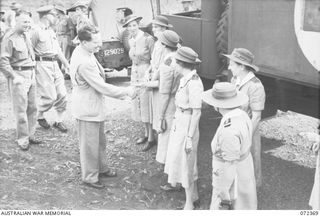 BISIATABU, NEW GUINEA. 1944-04-19. THE HONOURABLE E.J. WARD, MINISTER FOR EXTERNAL TERRITORIES IN THE AUSTRALIAN GOVERNMENT (1), GREETS NURSES FROM THE 47TH CAMP HOSPITAL, AUSTRALIAN ARMY NURSING ..