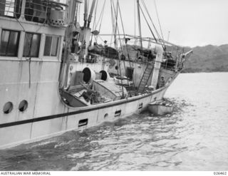 OFF PORT MORESBY, PAPUA. 1942-08-30. A CLOSE VIEW OF THE STARBOARD SIDE OF M.V. MALAITA WHERE THE SHIP WAS HIT BY A TORPEDO FROM AN ENEMY SUBMARINE OFF PORT MORESBY. THE VESSEL WAS TOWED INTO PORT ..