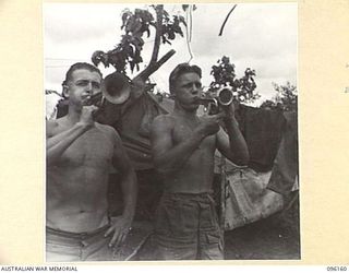 BRANDI, NEW GUINEA, 1945-09-07. PRIVATE J.E. MITCHELL (1) AND PRIVATE G.C. PARSONS (2), MEMBERS OF 35 INFANTRY BATTALION, BLOWING JAPANESE BUGLES