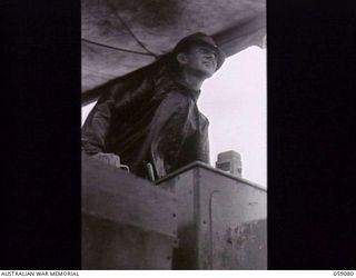 LAE, NEW GUINEA. 1943-10-17. SERGEANT ARTHUR FOLEY, "C" COMPANY, 542ND UNITED STATES BOAT AND SHORE REGIMENT, SKIPPER OF ONE OF THE BARGES CONVEYING TROOPS OF THE 29/46TH AUSTRALIAN INFANTRY ..