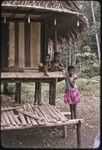 Kiriwina children on house veranda, one holding a ball