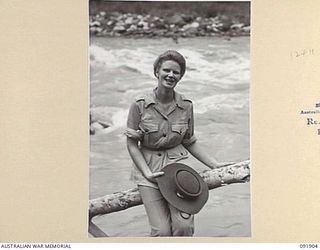 LAE, NEW GUINEA, 1945-05-18. SIGNALWOMAN W.F. ALFORD, AUSTRALIAN WOMEN'S ARMY SERVICE BARRACKS, ALONGSIDE THE BUSU RIVER DURING A TOUR OF THE AREA CONDUCTED BY ARMY AMENITIES SERVICE FOR AUSTRALIAN ..