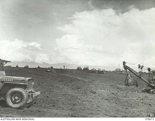 CAPE CUNNINGHAM, NEW BRITAIN. 1945-01-22. BULLDOZERS AND HEAVY EARTHMOVING EQUIPMENT OF THE 2/3RD RAILWAY CONSTRUCTION COMPANY WORKING ON THE CONSTRUCTION OF THE NEW AIRSTRIP
