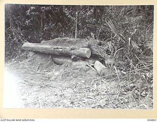 TOROKINA AREA, BOUGAINVILLE. 1945-08-08. A BUNKER AFTER IT HAS BEEN HIT BY A 75MM SHELL AT 50 YARDS WITH THE FUSE SET AT INSTANTANEOUS DURING TRIALS FOR THE WAR OFFICE OF AN M24 GENERAL CHAFFEE ..