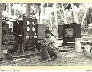 LABU POINT, LAE, NEW GUINEA. 1944-03-24. NX65433 WARRANT OFFICER CLASS 2 D. H. RAMSAY PICTURED AT WORK ON A GENERATING PLANT AT THE 1ST WATERCRAFT WORKSHOP. THE PLANT SUPPLIES THE UNIT AND BATTERY ..