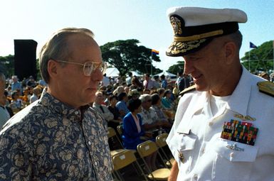 Secretary of the Navy H. Lawrence Garrett III talks with RADM Larry G. Vogt, director for plans and policy, U.S. Pacific Command, during the Survivors Day program at the USS Arizona Memorial. The program is part of the observance of the 50th anniversary of the Japanese attack on Pearl Harbor