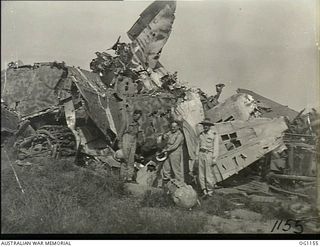 HOLLANDIA, DUTCH NEW GUINEA. C. 1944-06. THE MINISTER FOR WAR ORGANISATION OF INDUSTRY, JOHN DEDMAN (LEFT) AND THE MINISTER FOR AIR, ARTHUR DRAKEFORD (CENTRE), INSPECT WRECKED JAPANESE AIRCRAFT ON ..