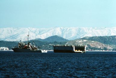 The small auxiliary floating dry dock ADEPT (AFDL-23) leaves Subic Bay for Guam in tow behind the salvage and rescue ship USS BRUNSWICK (ATS-3)