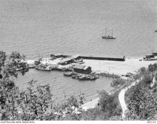 PORT MORESBY AREA, NEW GUINEA. 1943-12-29. FROM TUA-GUBA HILL LOOKING DOWN ON TO THE ROYAL AUSTRALIAN AIR FORCE MARINE SECTION. HERE ARE BASED PBY "CATALINA" SQUADRONS USED FOR LONG RANGE ..