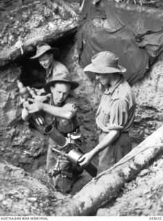 GOODVIEW, NEW GUINEA, 1943-08-10. TROOPS OF HEADQUARTERS COMPANY, 2/6TH BATTALION LOADING A THREE INCH MORTAR. LEFT TO RIGHT:- SX13315 PRIVATE (PTE) J. J. SILVY; NX105042 PTE R. A. CORNWELL; ..