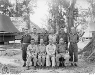 Group portrait of Catholic Chaplains of Headquarters 3 Division with Bishop T. Wade, US Bishop of the Solomon Islands.
Front Row (Left to Right)
NX164999 (N429587) Captain (Capt) Christopher ..