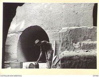 TUNNEL HILL ROAD, RABAUL, NEW BRITAIN. 1945-10-03. THE ENTRANCE TO TWO TUNNELS SEEN FROM THE INSIDE OF A THIRD. THE JAPANESE MADE EXTENSIVE USE OF TUNNEL SYSTEMS IN THE RABAUL AREA AFTER ..