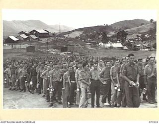 PORT MORESBY, NEW GUINEA. 1944-05-31. A MESS PARADE AT THE NEW GUINEA DETAILS DEPOT. THE CAMP, WHICH HAS TOTAL ACCOMMODATION FOR 3,000 TROOPS, CONTAINS ONLY ABOUT 1,000 MEN AT THE PRESENT TIME. A ..