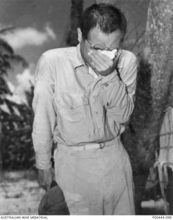GUAM 1945-08-15. CRYING UNASHAMEDLY, A JAPANESE POW HAS JUST HEARD A BROADCAST BY EMPEROR HIROHITO ANNOUNCING JAPAN'S UNCONDITIONAL SURRENDER. (NAVAL HISTORICAL COLLECTION)