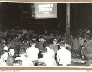 DUMPU, NEW GUINEA. 1943-12-10. TROOPS AT A PICTURE SHOW PUT ON BY THE 85TH AUSTRALIAN MOBILE CINEMA UNIT, AUSTRALIAN ARMY AMENITIES, 7TH AUSTRALIAN DIVISION