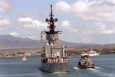 The large harbor tug WAXAHATCHIE (YTB 814) escorts the USS BREWTON (FF 1086) away from the pier at the conclusion of the designation and departure ceremony for the Unknown Serviceman of the Vietnam Era. The frigate is transporting the Unknown to Naval Air Station Alameda, California